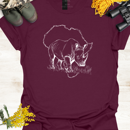 Maroon t-shirt with a rhino graphic on a wooden surface with camouflage boots and yellow flowers.
