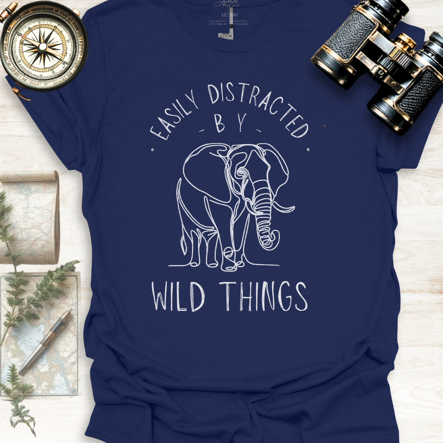 Navy blue wildlife graphic t-shirt with white elephant graphic and text 'Easily Distracted by Wild Things, outdoor lifestyle apparel by Africa Wild Child.